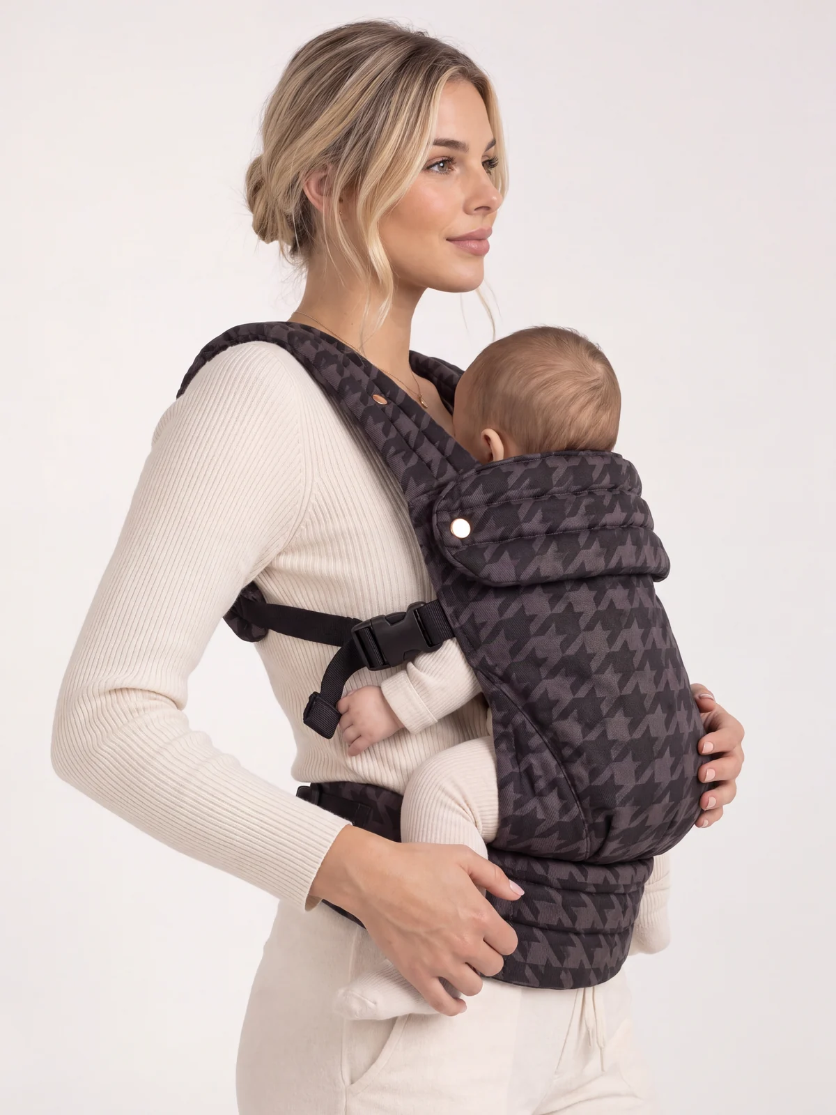 Closer studio view of the Philipa Carrier in Onyx with a baby facing inward